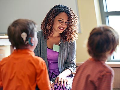 a USU music therapy student working with young clients