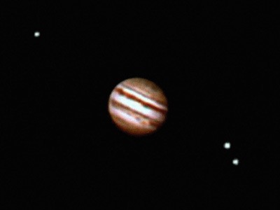 The planet Jupiter and moons in the night sky
