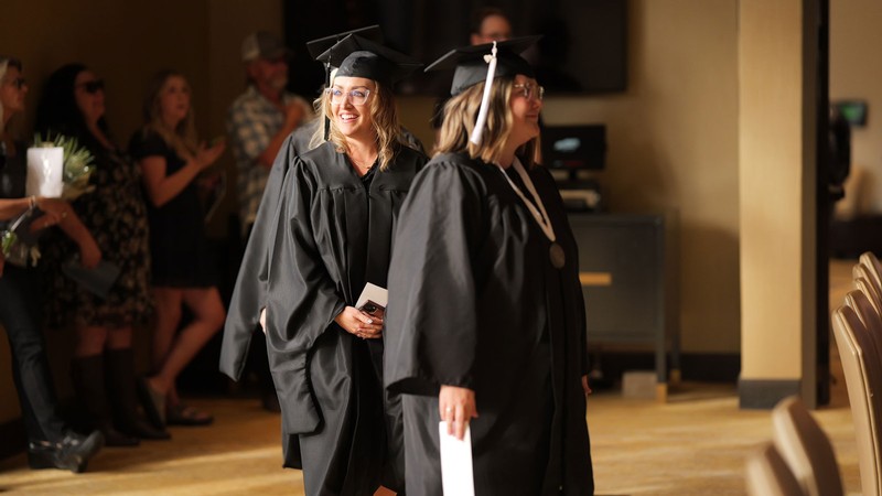 People in graduation robes.
