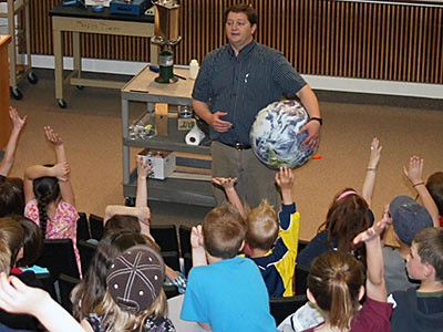 USU's James Coburn at USU Physics Demo Show with a crowd