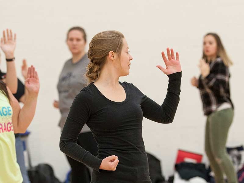 woman holds self-defense pose