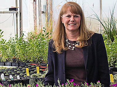 Donna Minch, Regional Campus faculty, in a greenhouse