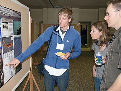 a student doing a poster presentation at a conference