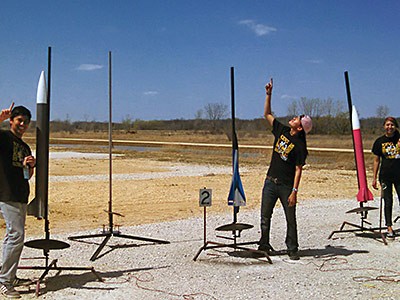 Three members of the USU Eastern Engineering Team with rockets