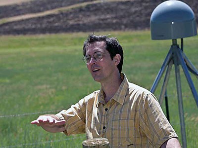 USU geophysicist Tony Lowry near an Earthscope GPS receiver in Wellsville Canyon