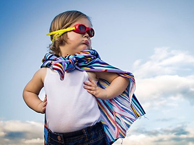 child dressed up as a superhero