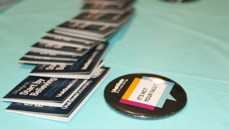 Start by Believing button and brochures displayed on a table.