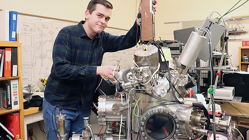 Trace Taylor uses a vacuum chamber to study materials from a satellite in a USU lab in Logan.