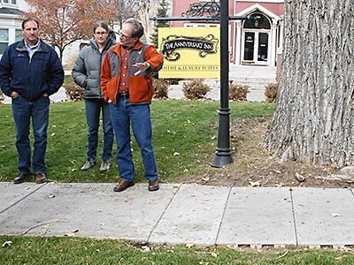 USU researchers and Logan City officials inspecting a recycled sidewalk tile in downtown Logan