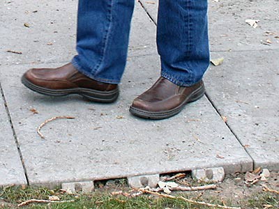 a close-up view of a recycled sidewalk tile in use