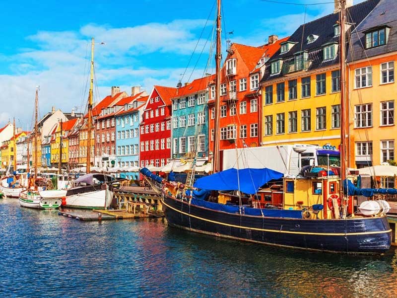 Scandinavian city with boats in the water