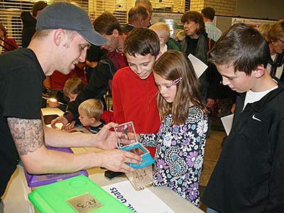Scientist shows spiders to children at Science Unwrapped