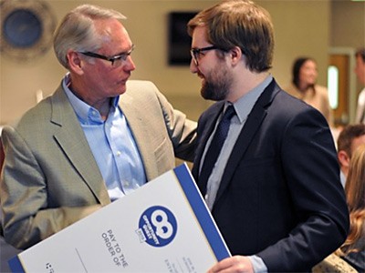presenting an oversized check at the entrepreneur competition