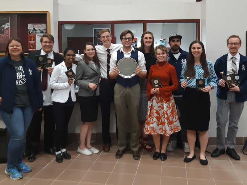 A group photo of the 12-member USU Speech and Debate Team.