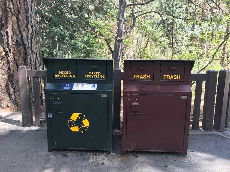 trash and recycle bins in the forest