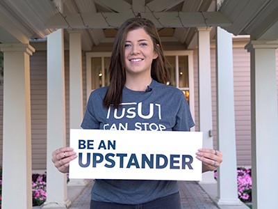 USU student Felicia Gallegos holding Updstander poster