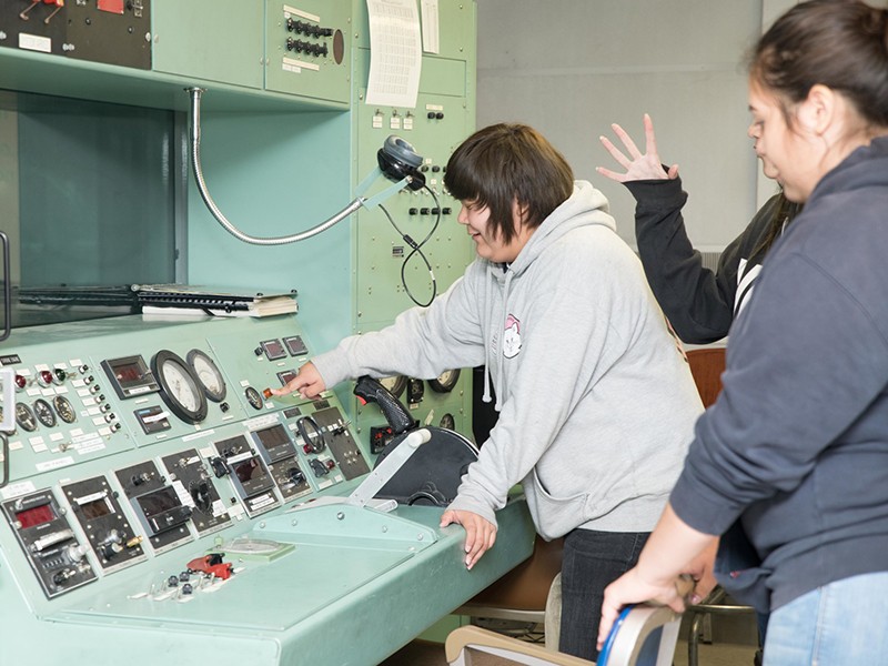 Ute Tribe students looking over an instrument panel
