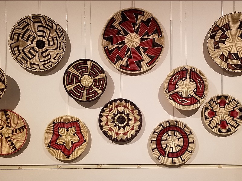 a wall of woven baskets