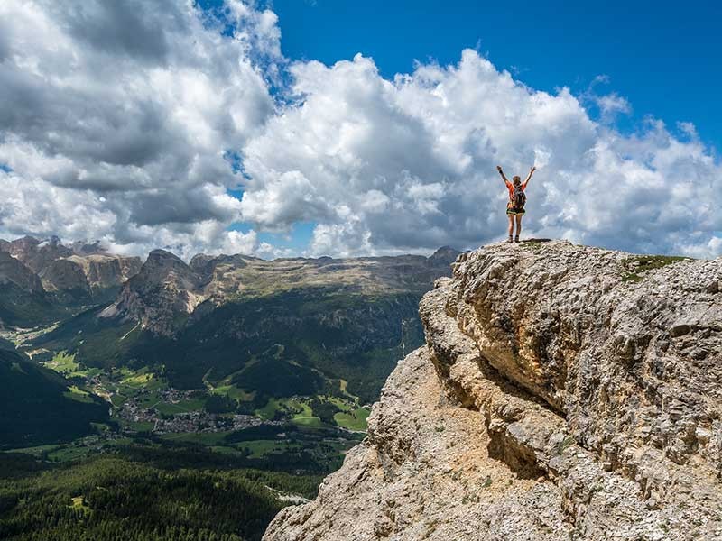 hiker standing over scenic mountain vista