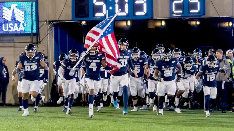 Utah State football players in Maverik Stadium.