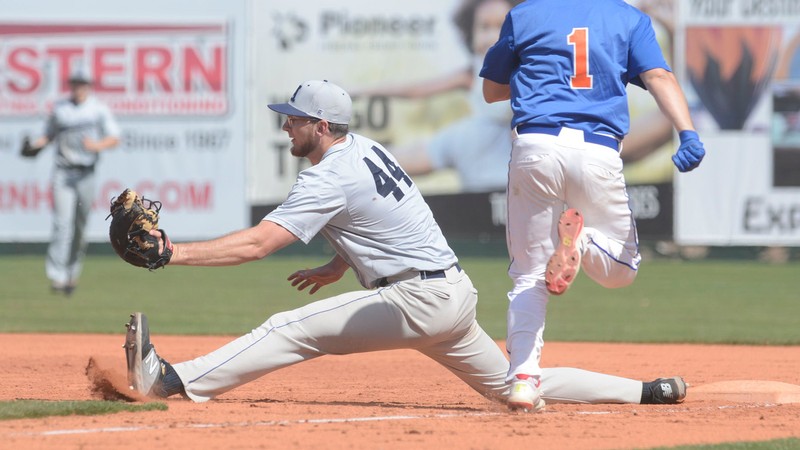 USU baseball team member catches a ball.