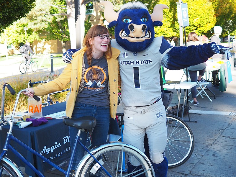 USU student on bike with Big Blue