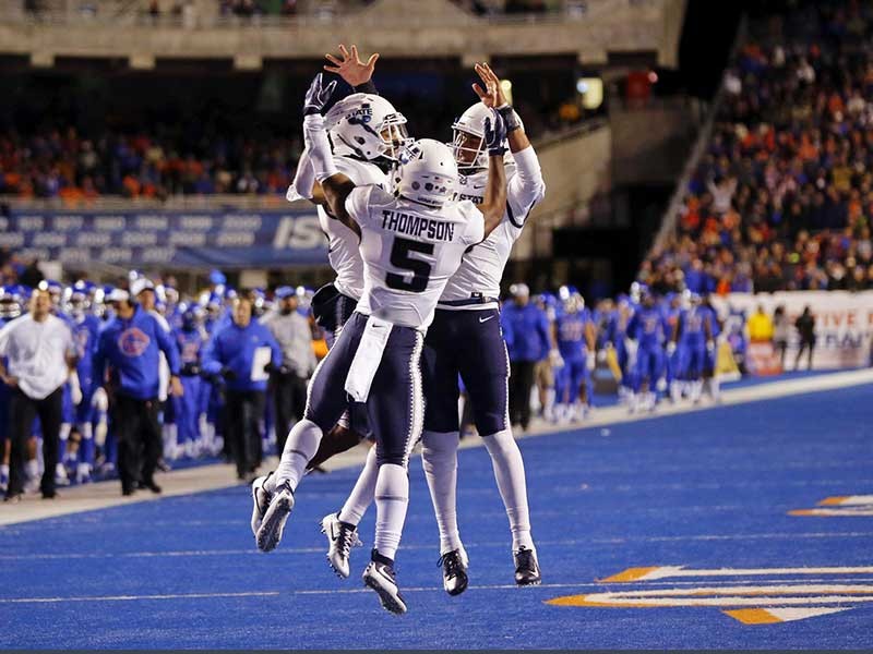 football players in congratulatory high-five