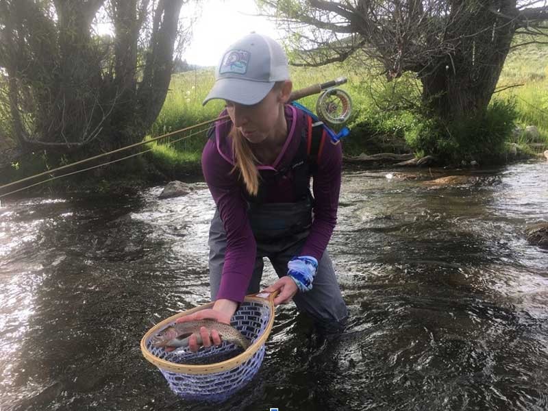 angler in the Yellowstone River watershed holding a fish
