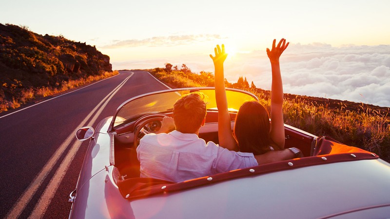 couple driving in a convertible.