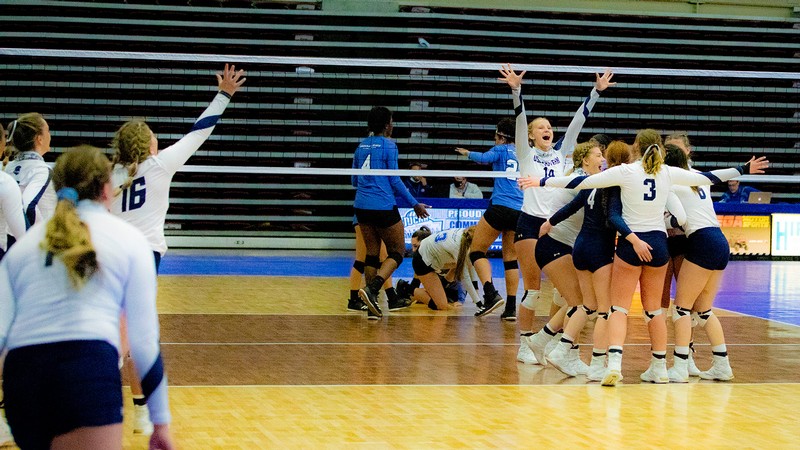 USU Eastern volleyball team celebrates on the court.