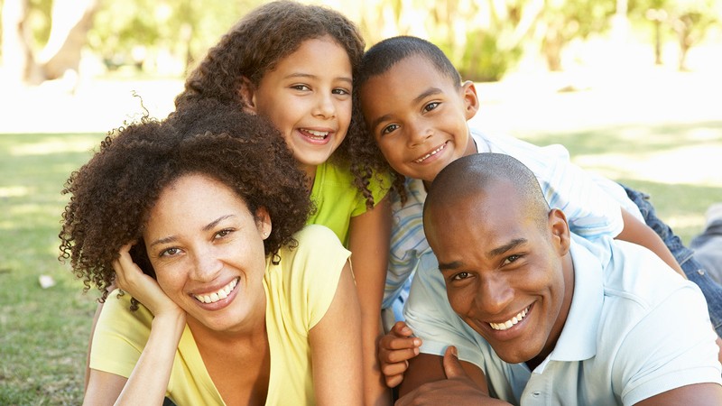 mother and father huddle in with two children.