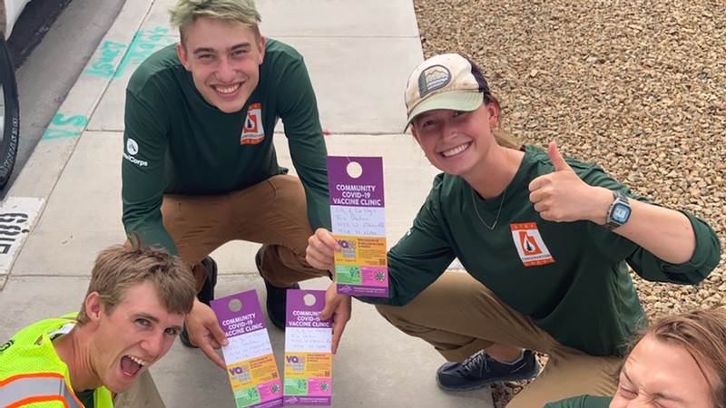UCC volunteers assisting distributing information materials about COVID vaccination.