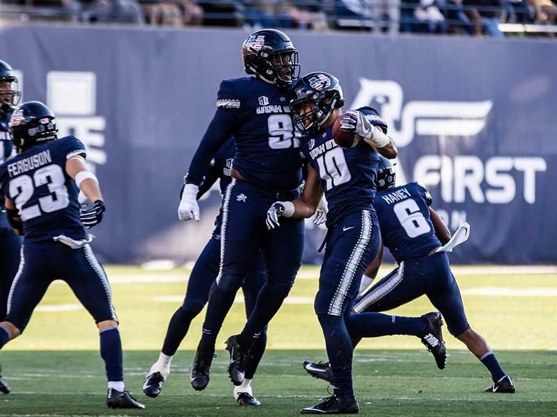 USU Aggie football players on the field