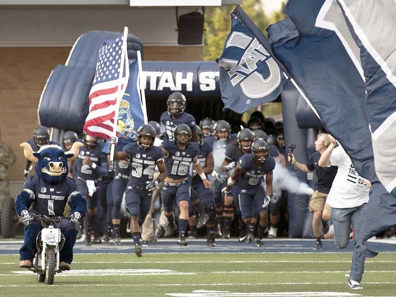 USU Football players running onto the field