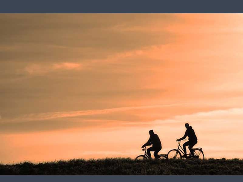 bikers with a sunset in the background