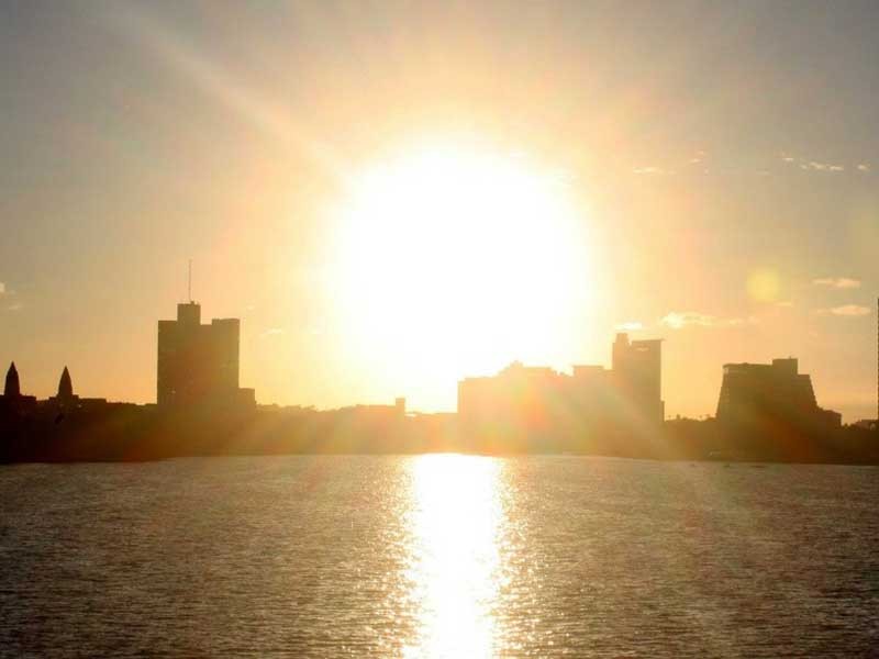 city skyline with bright sun