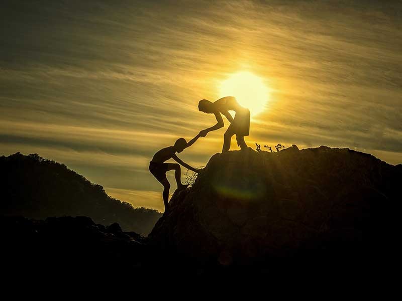 person helping someone up