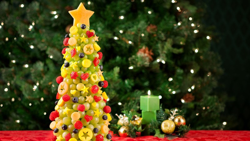 Festive holiday tree made of fruit.
