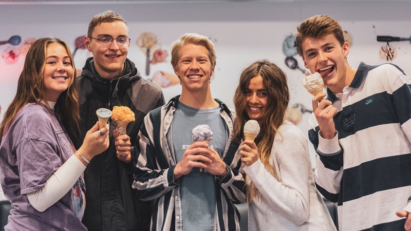 College students hold ice cream cones.