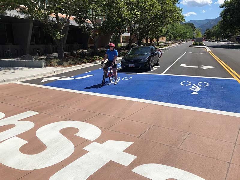 cyclist on Aggie Bull-evard in a bike box.