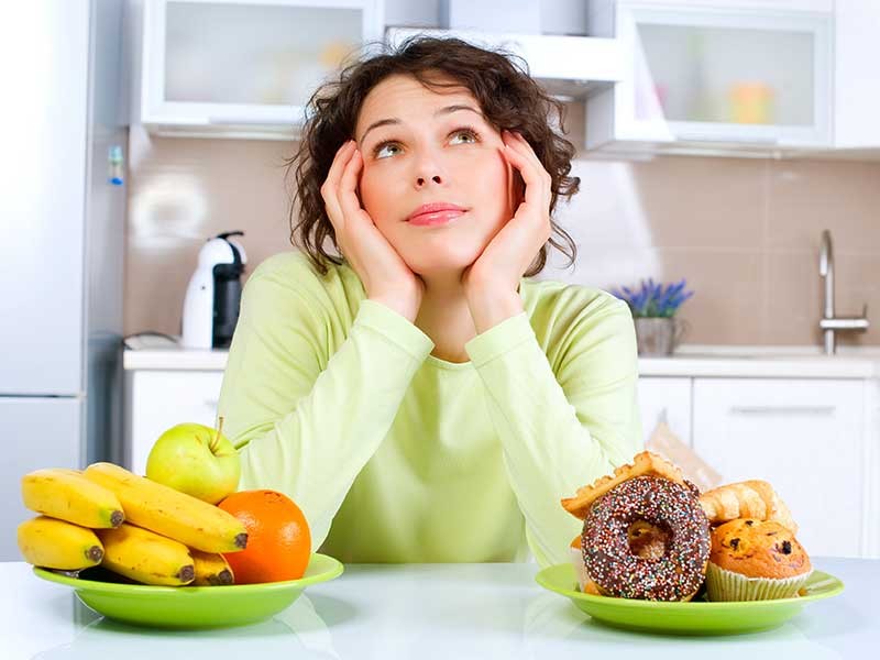 woman with a variety of foods before her