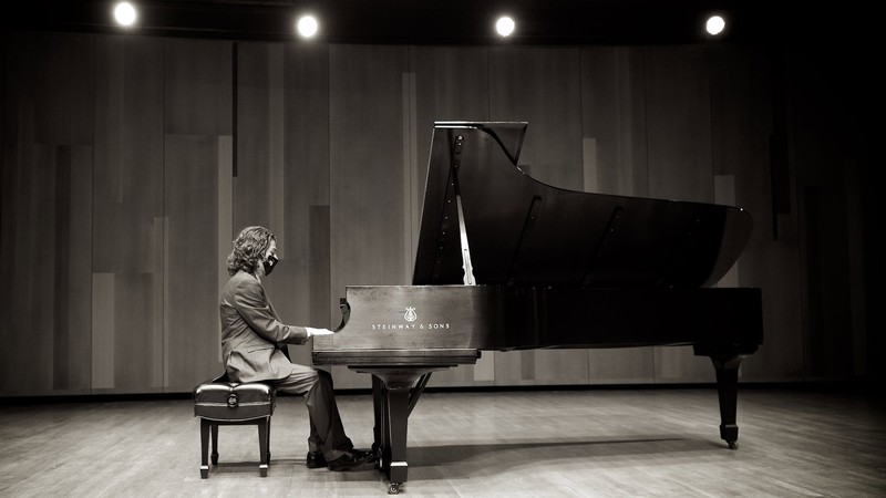 Piano player in the Russell/Wanlass Performance Hall.