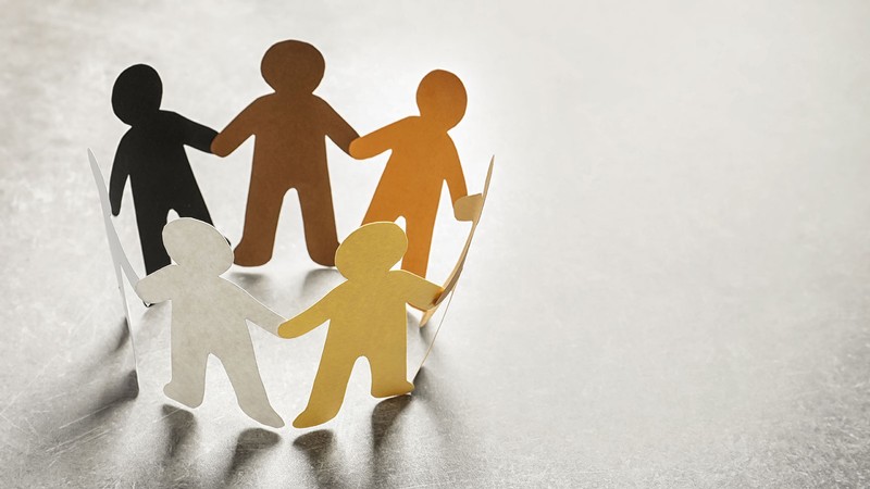 paper doll cutouts of varying shades.