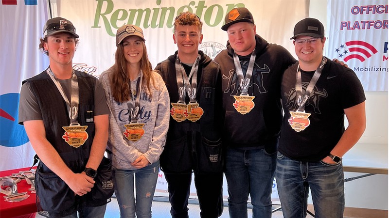 Five students pose for a photo, each with an award medal around their neck