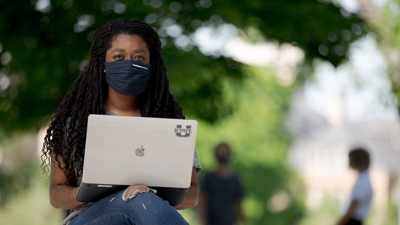 USU student working on a laptop.