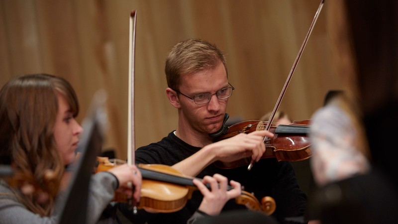 Members of USU’s Symphony Orchestra on stage. *Note: Image taken prior to COVID-19 Pandemic.