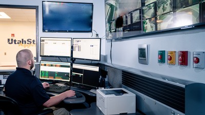 A Utah State University Police dispatcher monitors systems on the Logan campus.