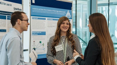 People discussing a research poster.