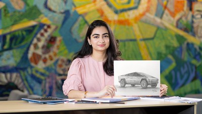 Marium Rasheed holds a drawing of a Tesla Cybertruck.