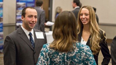 People talk at a professional networking event.